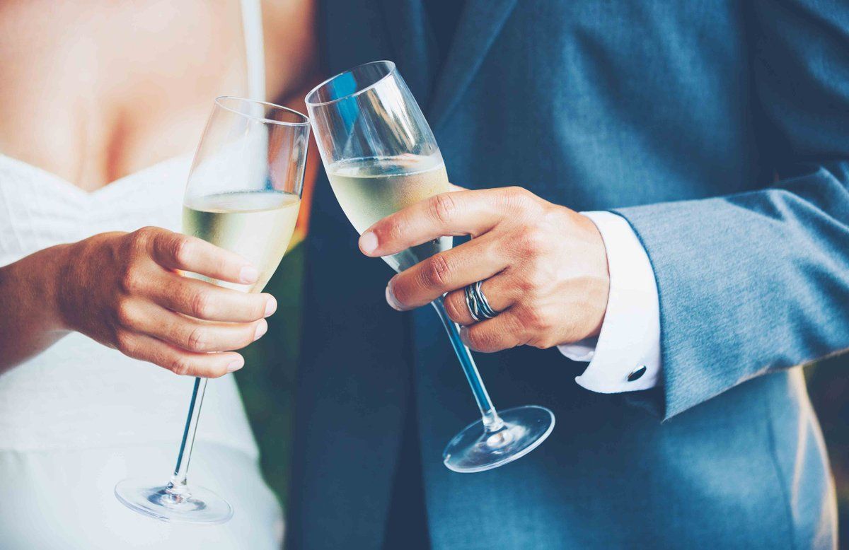Birde and Groom holding Champagne glasses