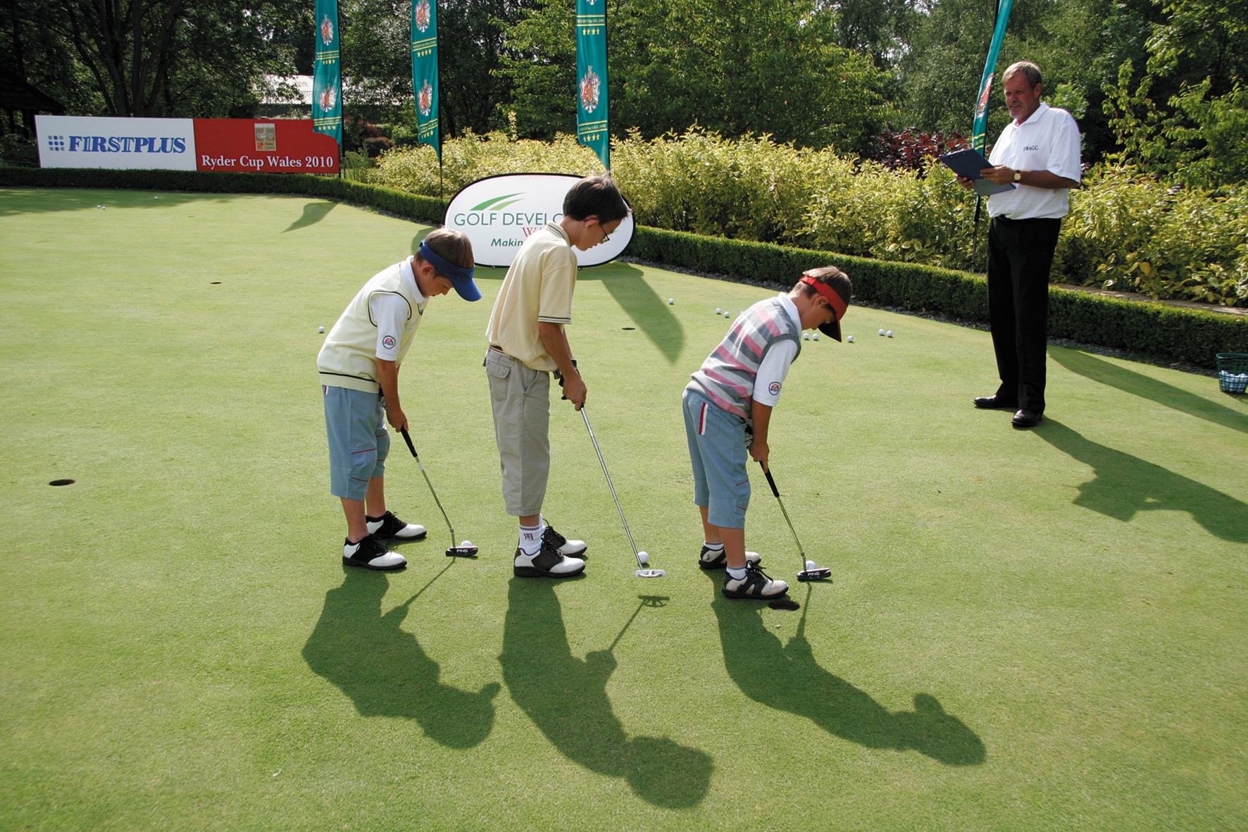 Three young boys having a golf lesson at the Vale Resort 