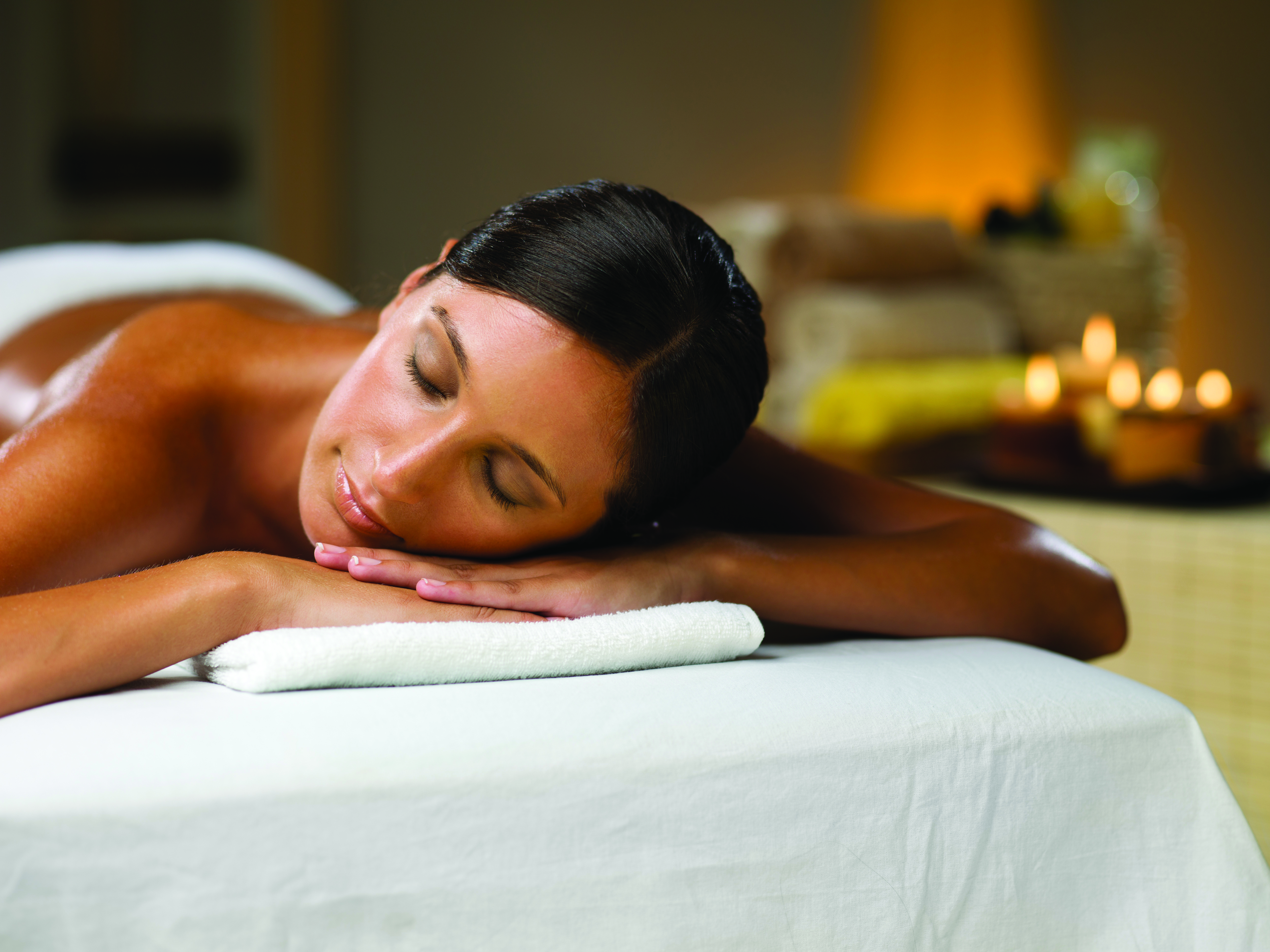 Woman lying on white spa bed 